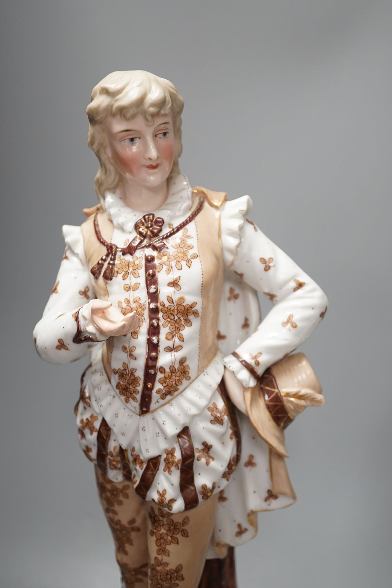A pair of large French porcelain figures, 38cm, and a figural group en suite